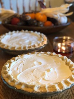 two pies sitting on top of a wooden table